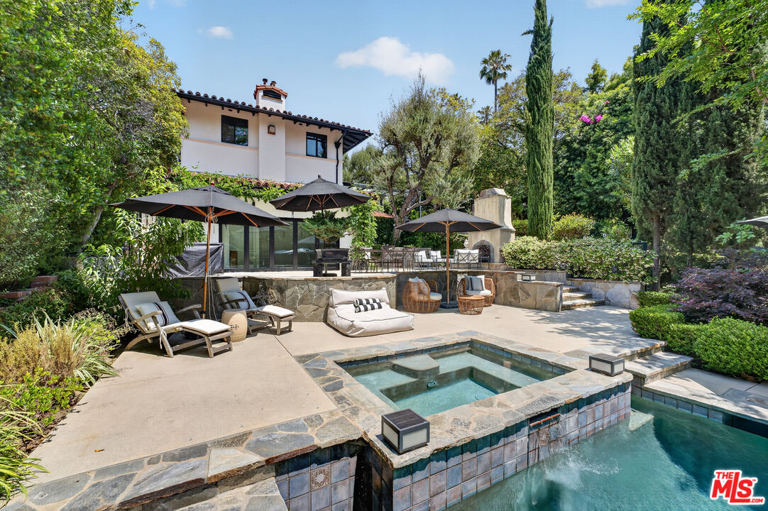 760 South San Rafael Avenue Pasadena, CA 91105 - Photo 2 of 45 a view of a patio with couches table and chairs under an umbrella with large trees