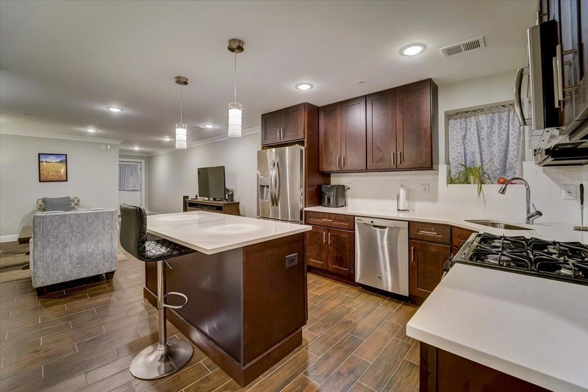 2765 John F. Kennedy Boulevard, Unit 1 Jersey City, NJ 07306 - Photo 16 of 33 a kitchen with stainless steel appliances granite countertop a sink a stove a refrigerator and a microwave