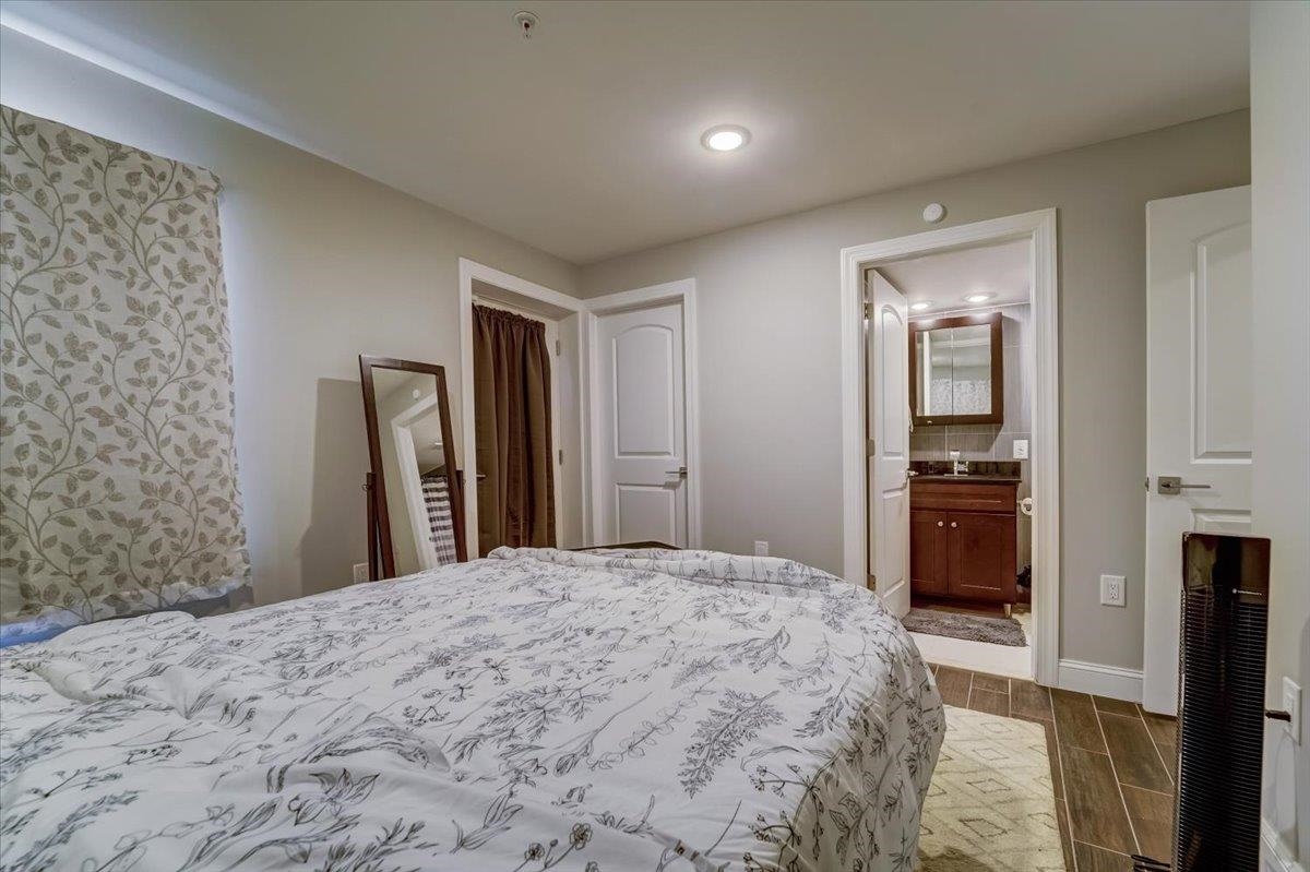 2765 John F. Kennedy Boulevard, Unit 1 Jersey City, NJ 07306 - Photo 20 of 33 a large bedroom with a bed and a view of kitchen