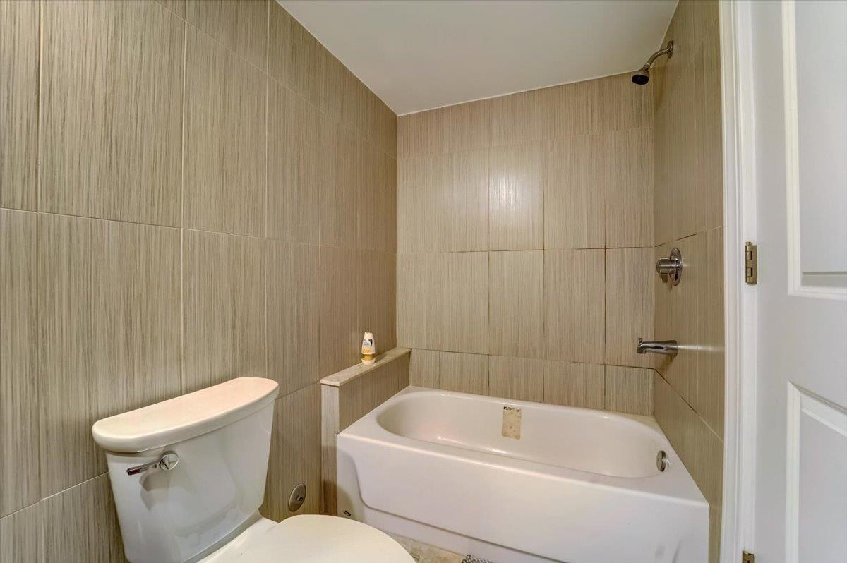 2765 John F. Kennedy Boulevard, Unit 1 Jersey City, NJ 07306 - Photo 24 of 33 a white bath tub sitting next to a white toilet and sink