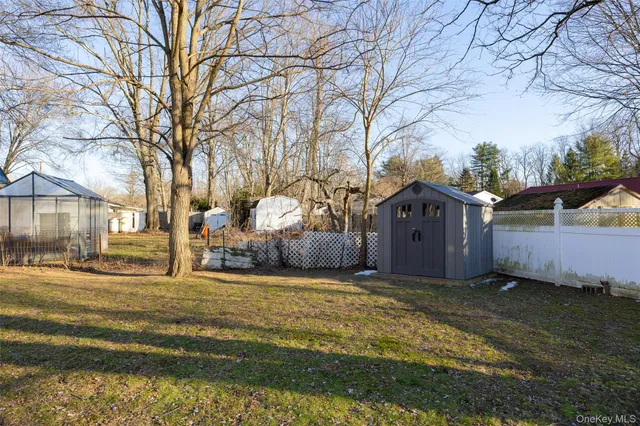 a view of a house with a yard covered in snow
