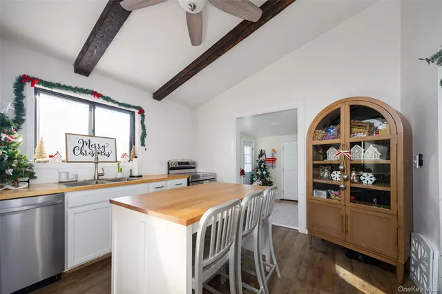 a view of a dining room with furniture and a window
