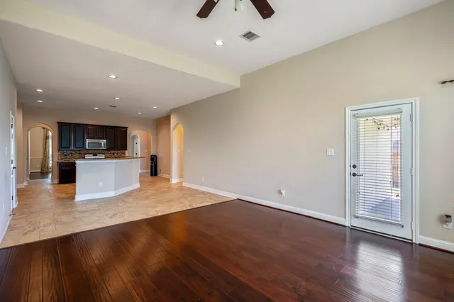 an open space with kitchen view and wooden floor