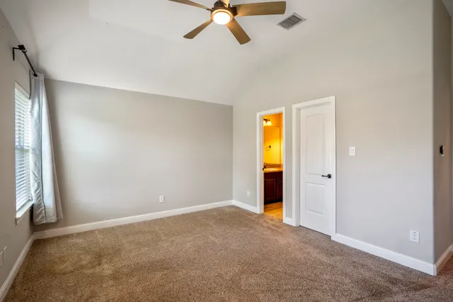 a bathroom with a granite countertop sink a toilet and a mirror