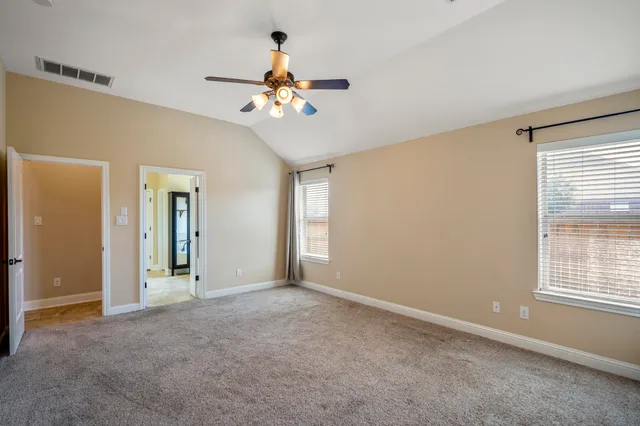 a spacious bathroom with a granite countertop tub sink and mirror