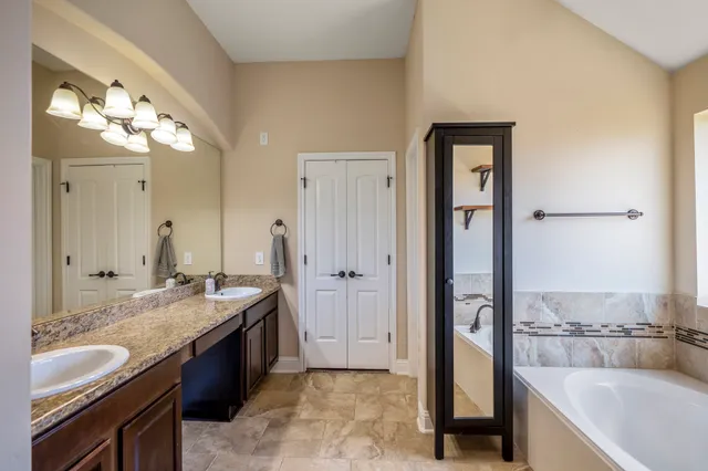 a bathroom with a bathtub and a shower