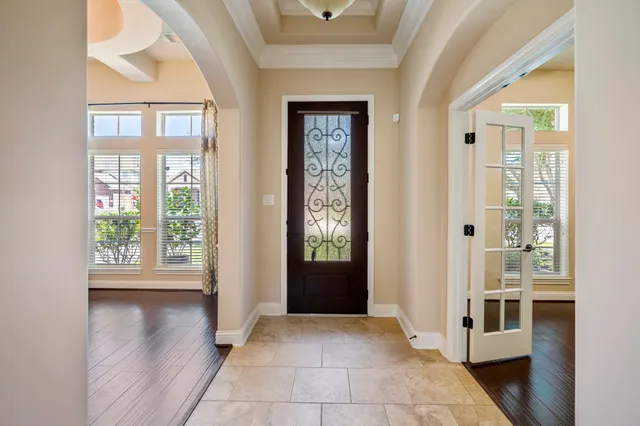 a view of a hallway with wooden floor and a livingroom