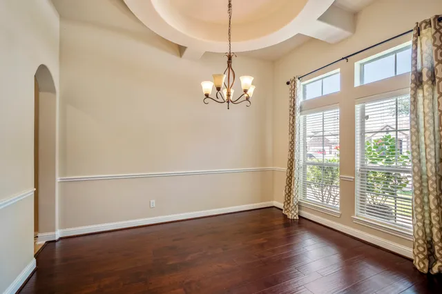 a view of a livingroom with wooden floor and a large window
