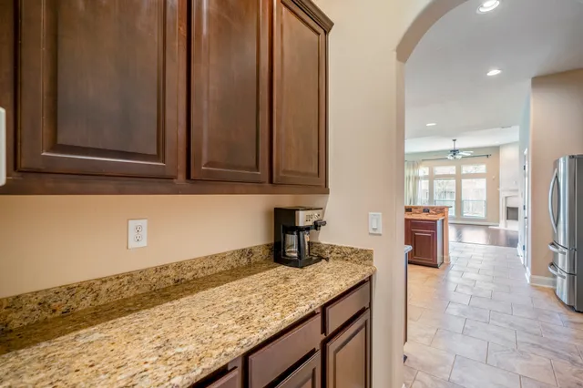 a kitchen with granite countertop a sink a stove and cabinets