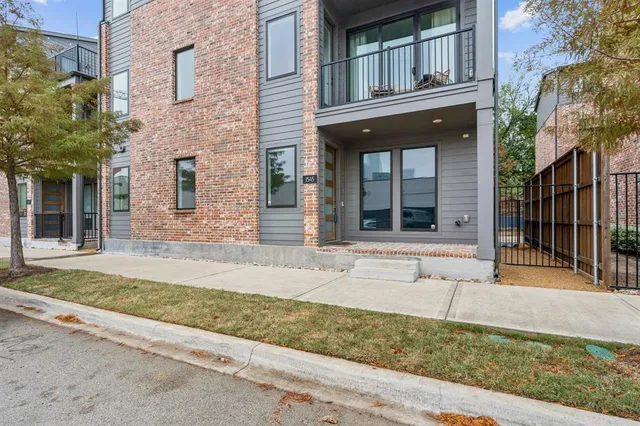 front view of a brick house with a large window