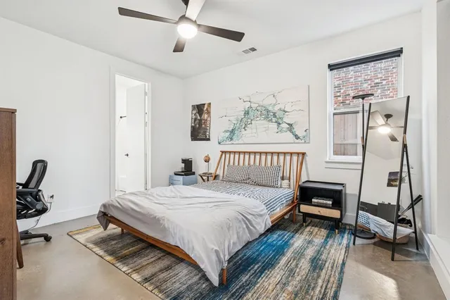 a bedroom with a bed a desk and chair