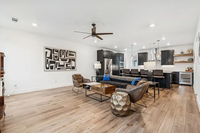 a living room with furniture and kitchen view
