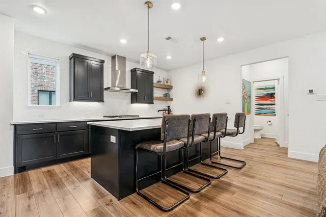a large kitchen with stainless steel appliances kitchen island granite countertop a sink counter space and cabinets