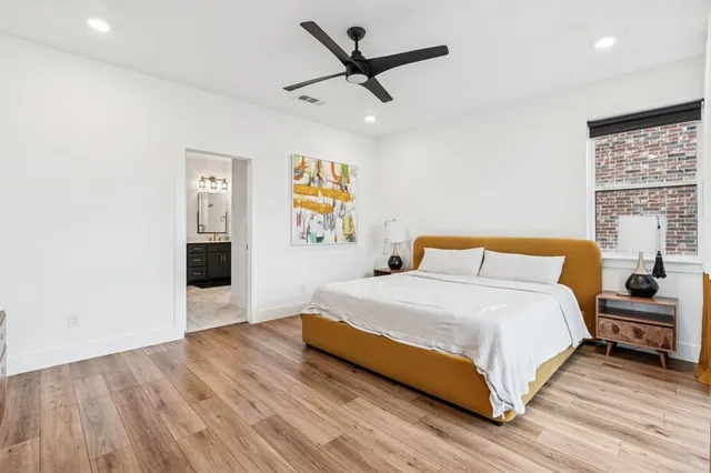 a spacious bedroom with a bed and a table