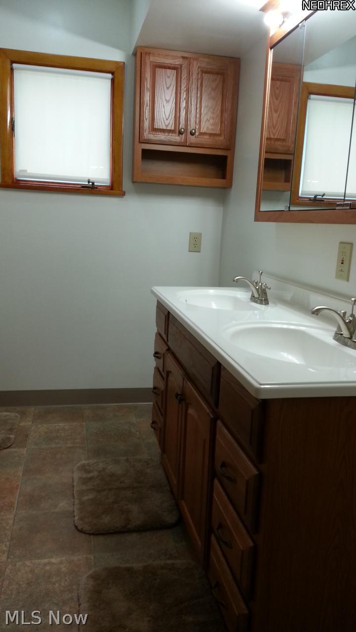 1998 Wyndham Road Akron, OH 44313 - Photo 16 of 25 Fully updated hallway bath. Tub/shower combo. New double vanity and storage cabinets. New flooring, toilet, plumbing and paint.