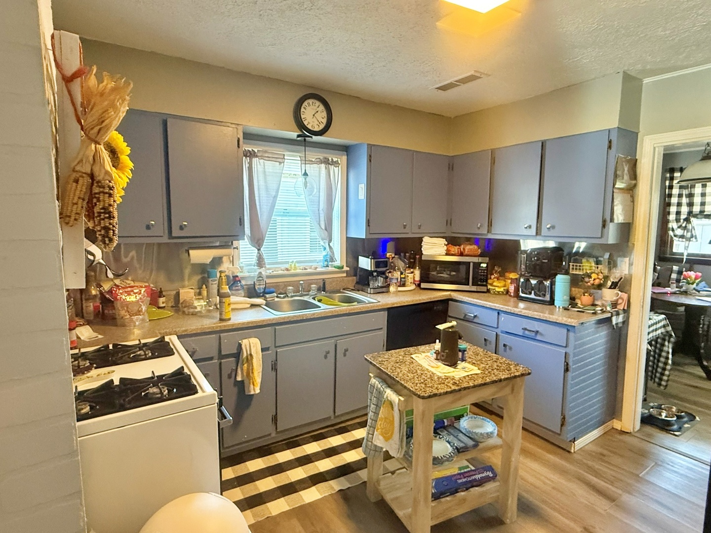 204 West 18th Street Metropolis, IL 62960 - Photo 3 of 12 a kitchen with a sink appliances and cabinets