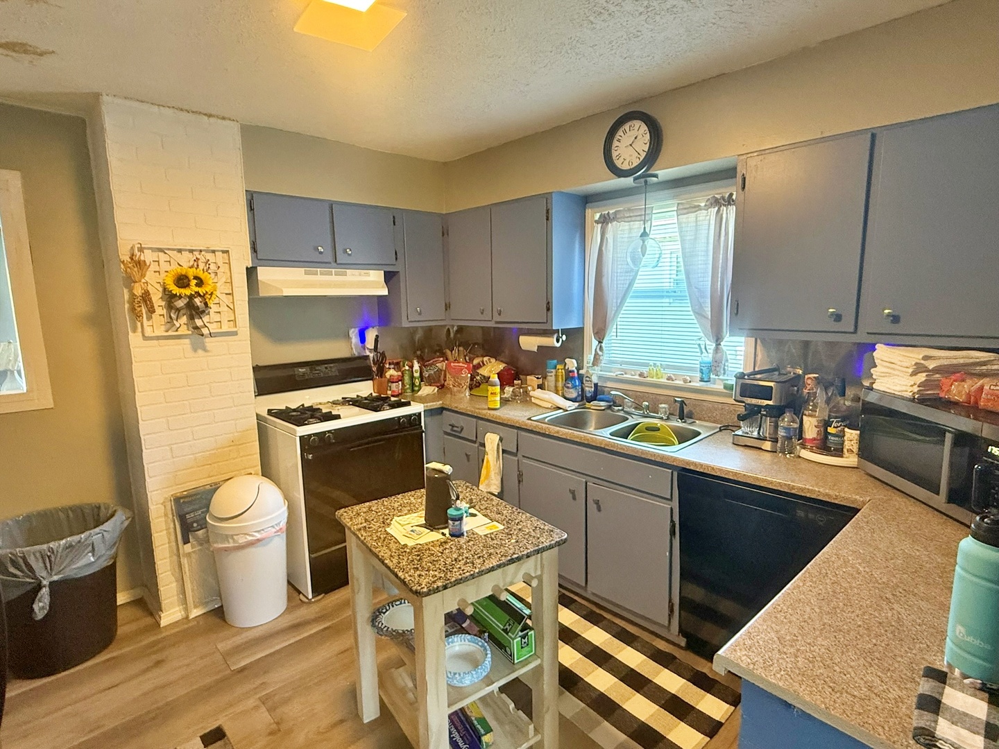 204 West 18th Street Metropolis, IL 62960 - Photo 4 of 12 a kitchen with a sink a stove a refrigerator cabinets and dining table