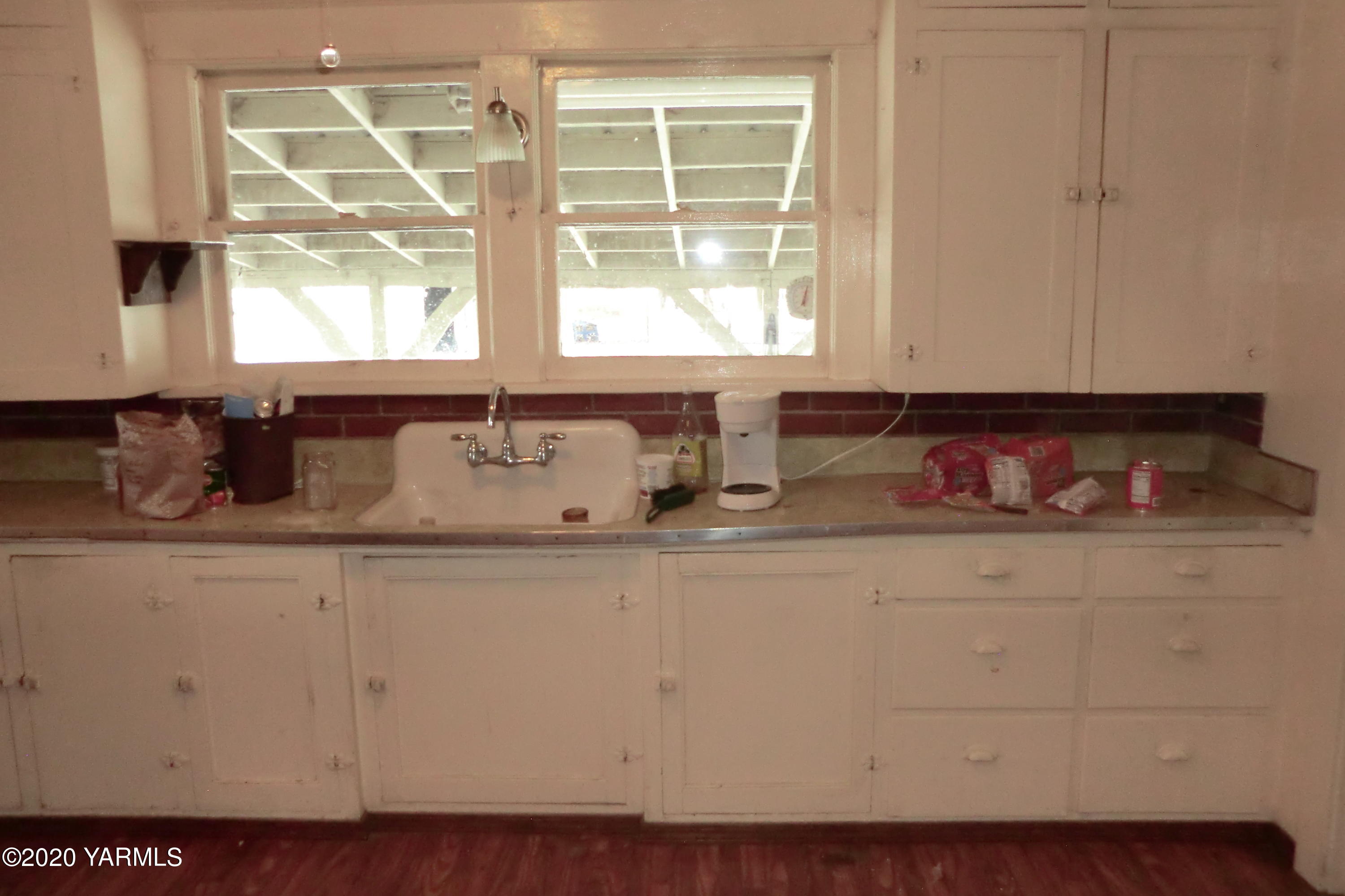 5404 Mieras Road Moxee, WA 98901 - Photo 9 of 27 a kitchen with granite countertop white cabinets and window