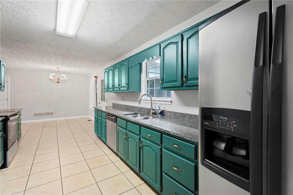 6854 John West Road Winston, GA 30187 - Photo 17 of 46 a kitchen with stainless steel appliances granite countertop a refrigerator and a sink