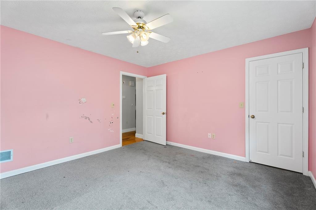 6854 John West Road Winston, GA 30187 - Photo 22 of 46 an empty room with a ceiling fan and a window