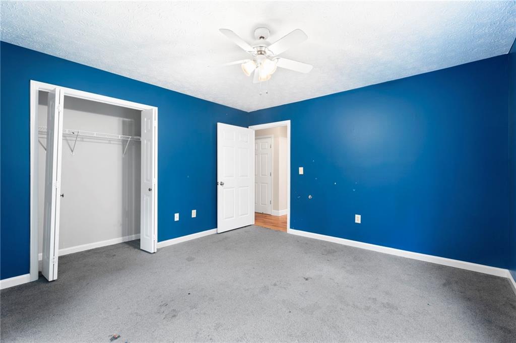 6854 John West Road Winston, GA 30187 - Photo 24 of 46 an empty room with closet and fan