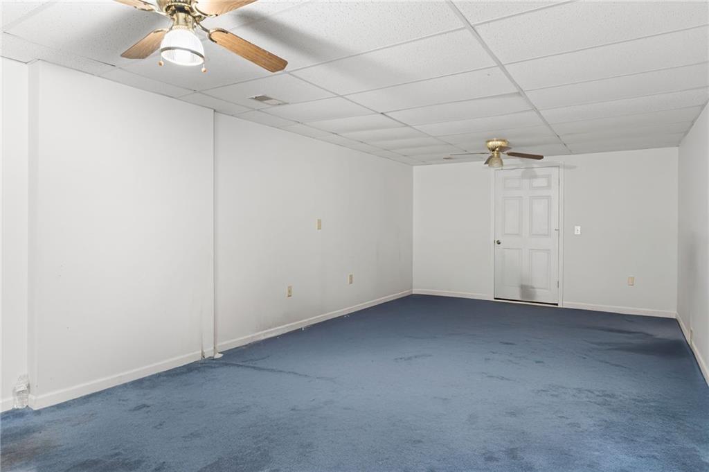 6854 John West Road Winston, GA 30187 - Photo 33 of 46 an empty room with a ceiling fan and a window