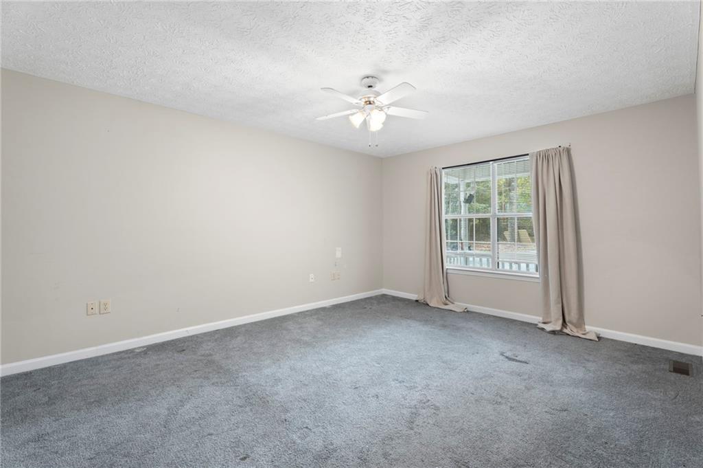 6854 John West Road Winston, GA 30187 - Photo 8 of 46 an empty room with windows and fan