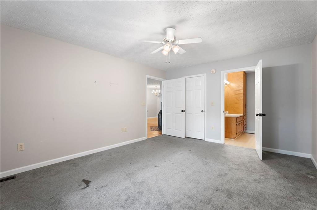 6854 John West Road Winston, GA 30187 - Photo 10 of 46 an empty room with chandelier fan and windows