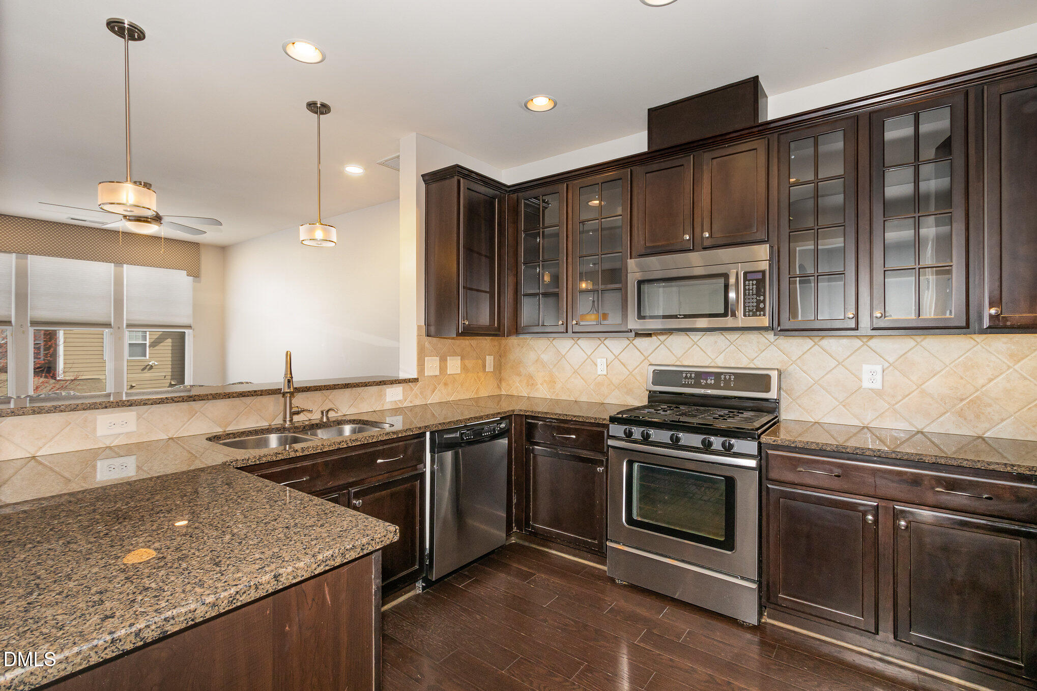 9142 Falkwood Road Raleigh, NC 27617 - Photo 9 of 33 a kitchen with stainless steel appliances granite countertop stove top oven and cabinets