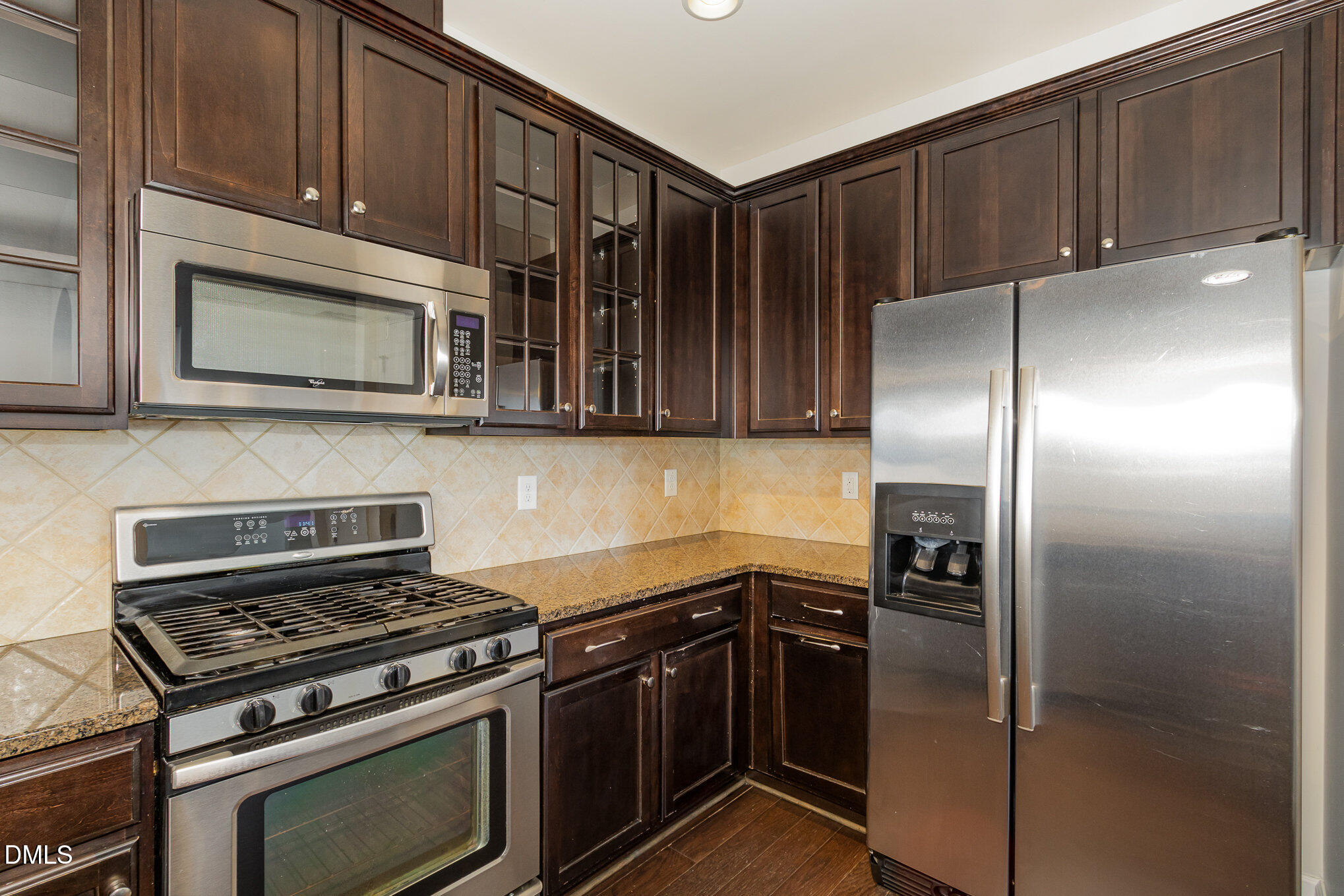 9142 Falkwood Road Raleigh, NC 27617 - Photo 10 of 33 a kitchen with granite countertop a stove microwave and refrigerator