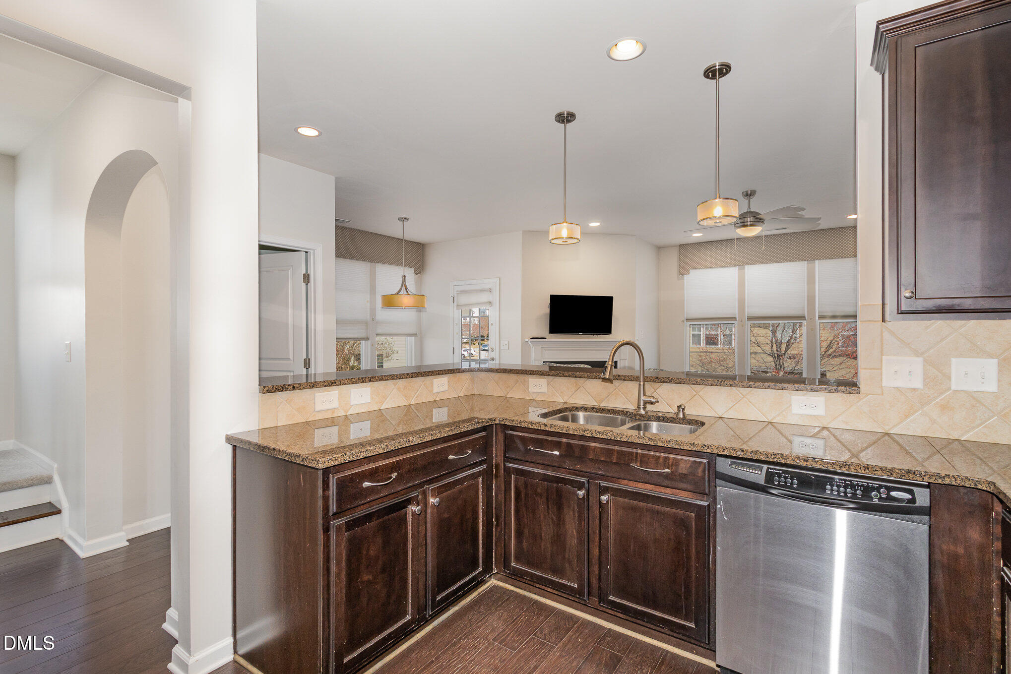 9142 Falkwood Road Raleigh, NC 27617 - Photo 11 of 33 a kitchen with stainless steel appliances granite countertop a sink a stove and a wooden floor