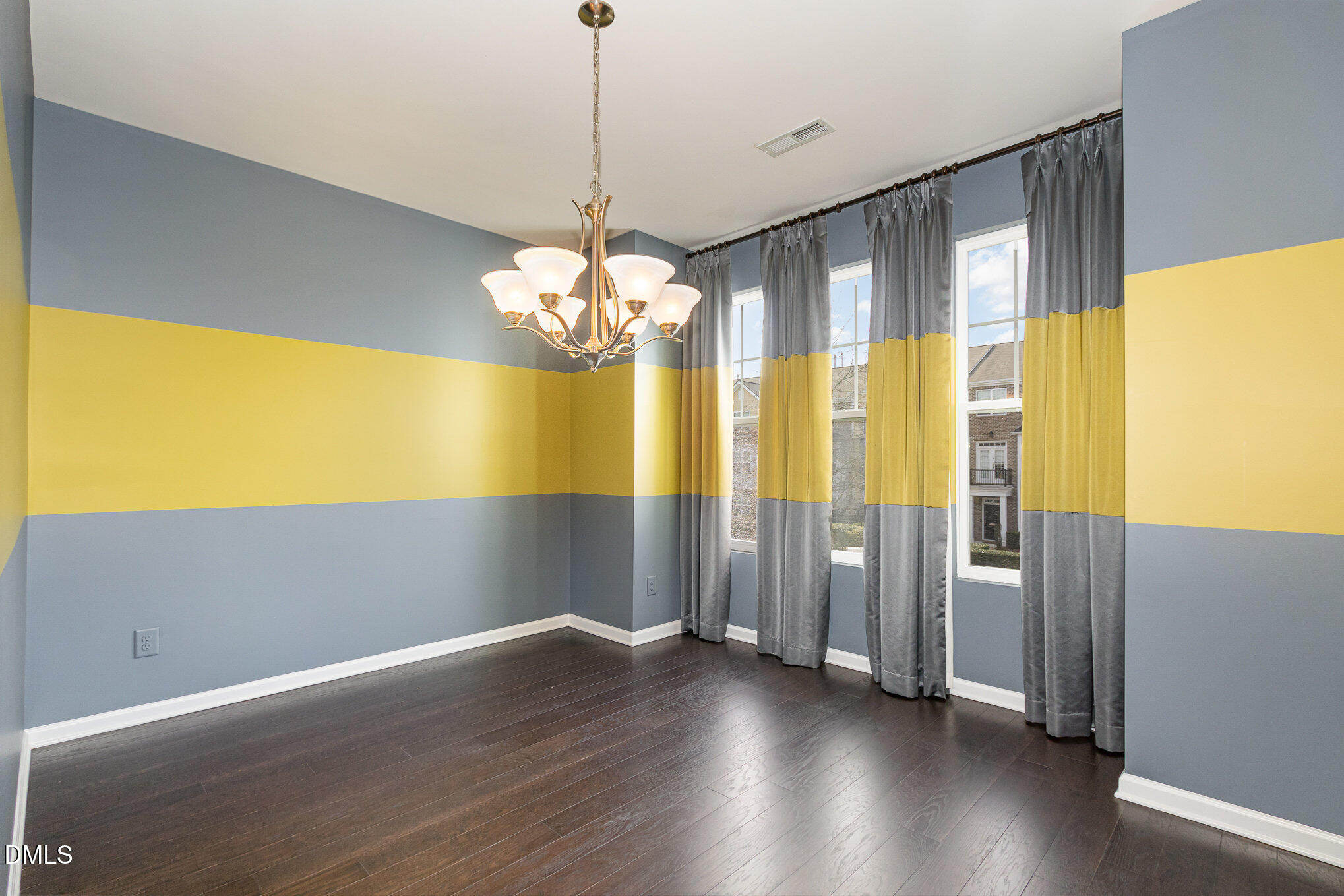 9142 Falkwood Road Raleigh, NC 27617 - Photo 12 of 33 a view of an empty room with wooden floor and a window