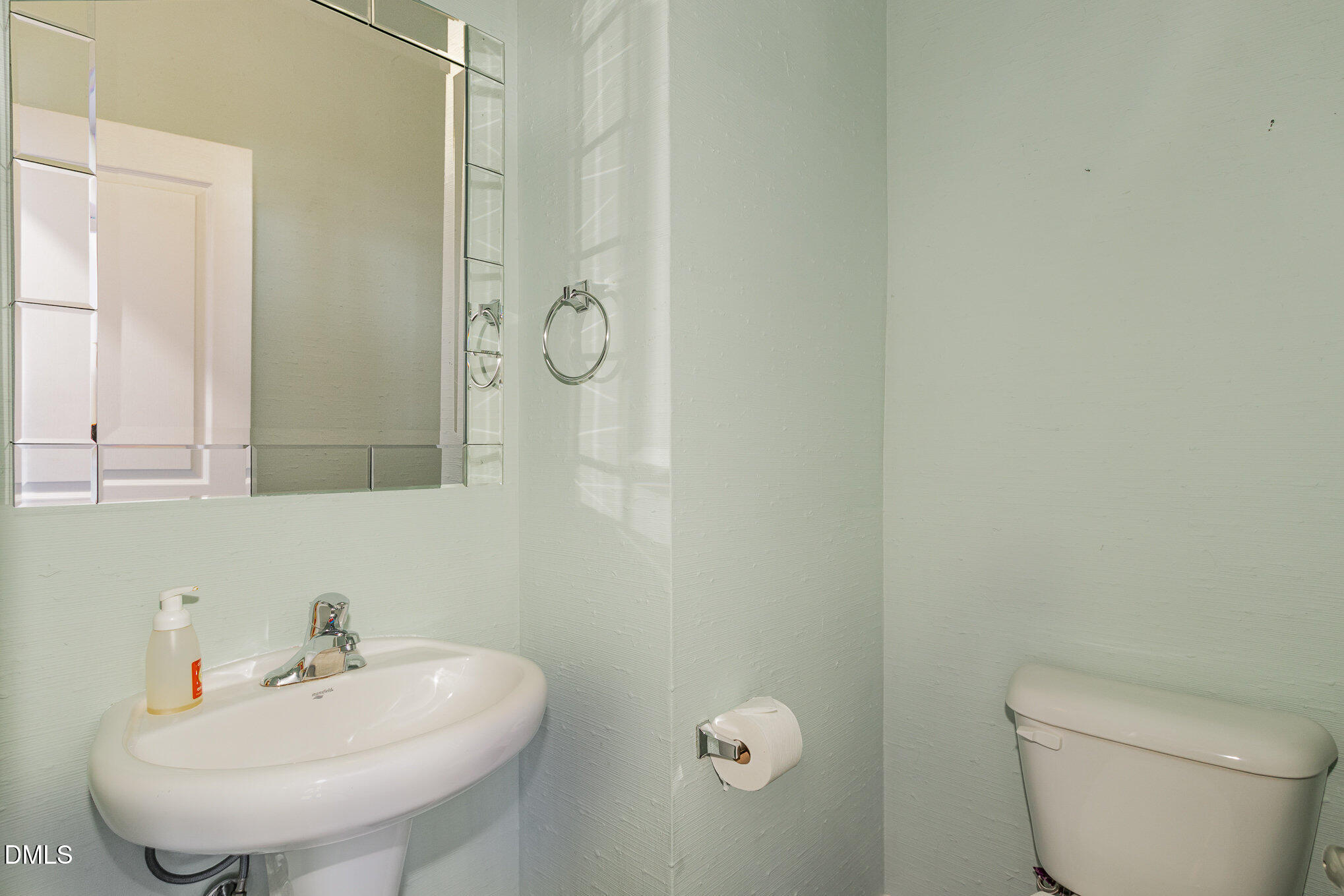 9142 Falkwood Road Raleigh, NC 27617 - Photo 15 of 33 a bathroom with a sink a toilet and mirror