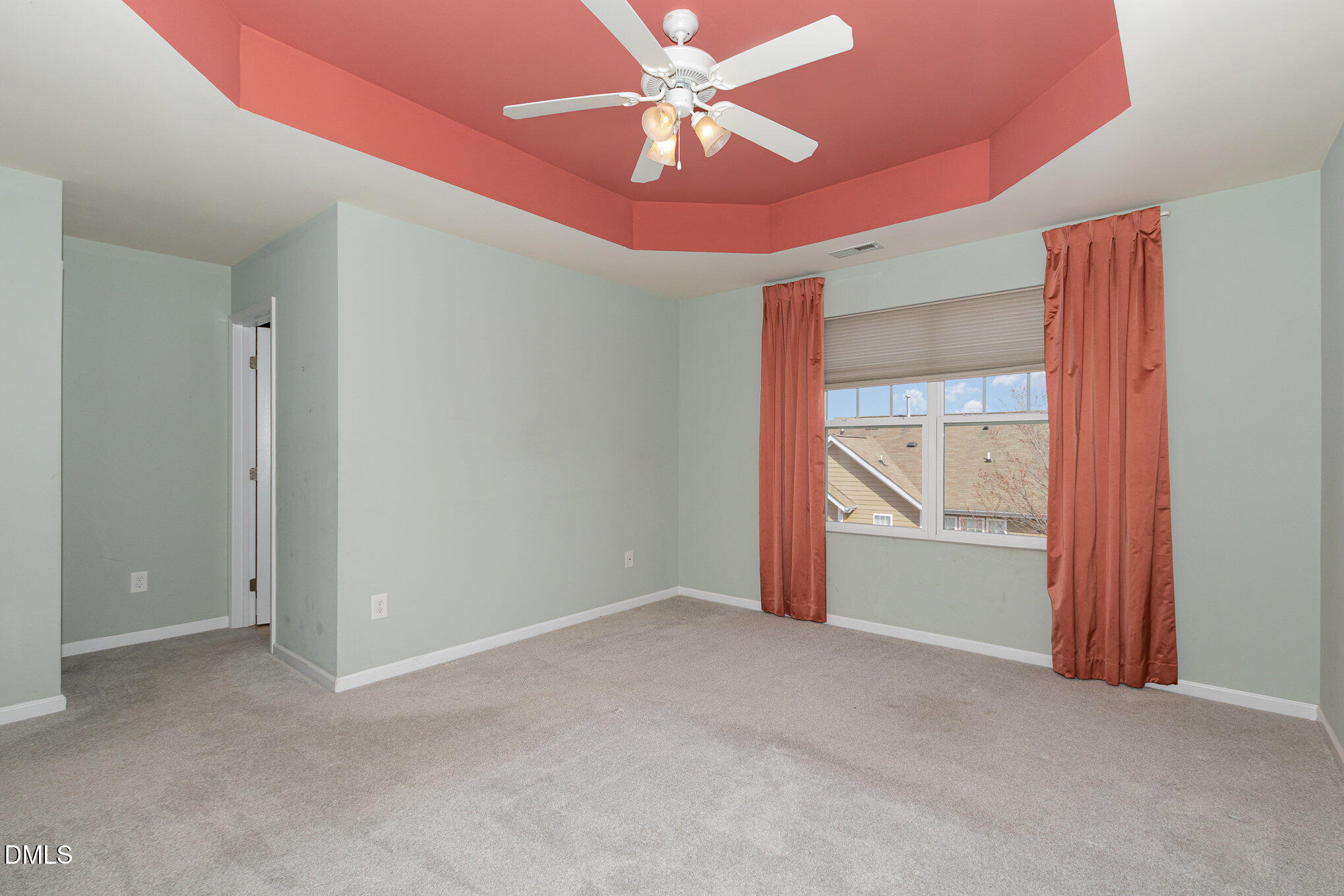 9142 Falkwood Road Raleigh, NC 27617 - Photo 18 of 33 an empty room with chandelier fan