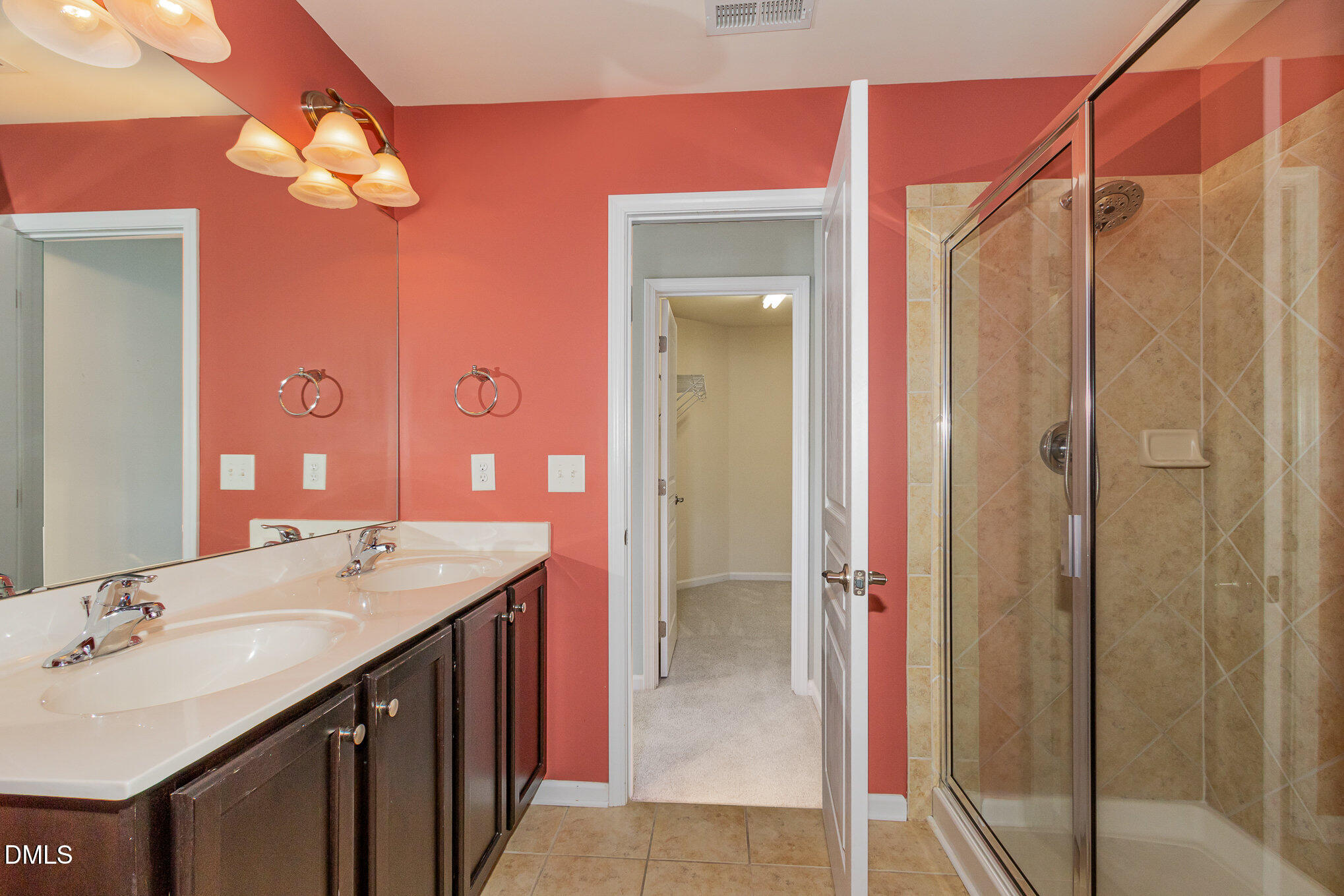 9142 Falkwood Road Raleigh, NC 27617 - Photo 19 of 33 a bathroom with a double vanity sink mirror and shower