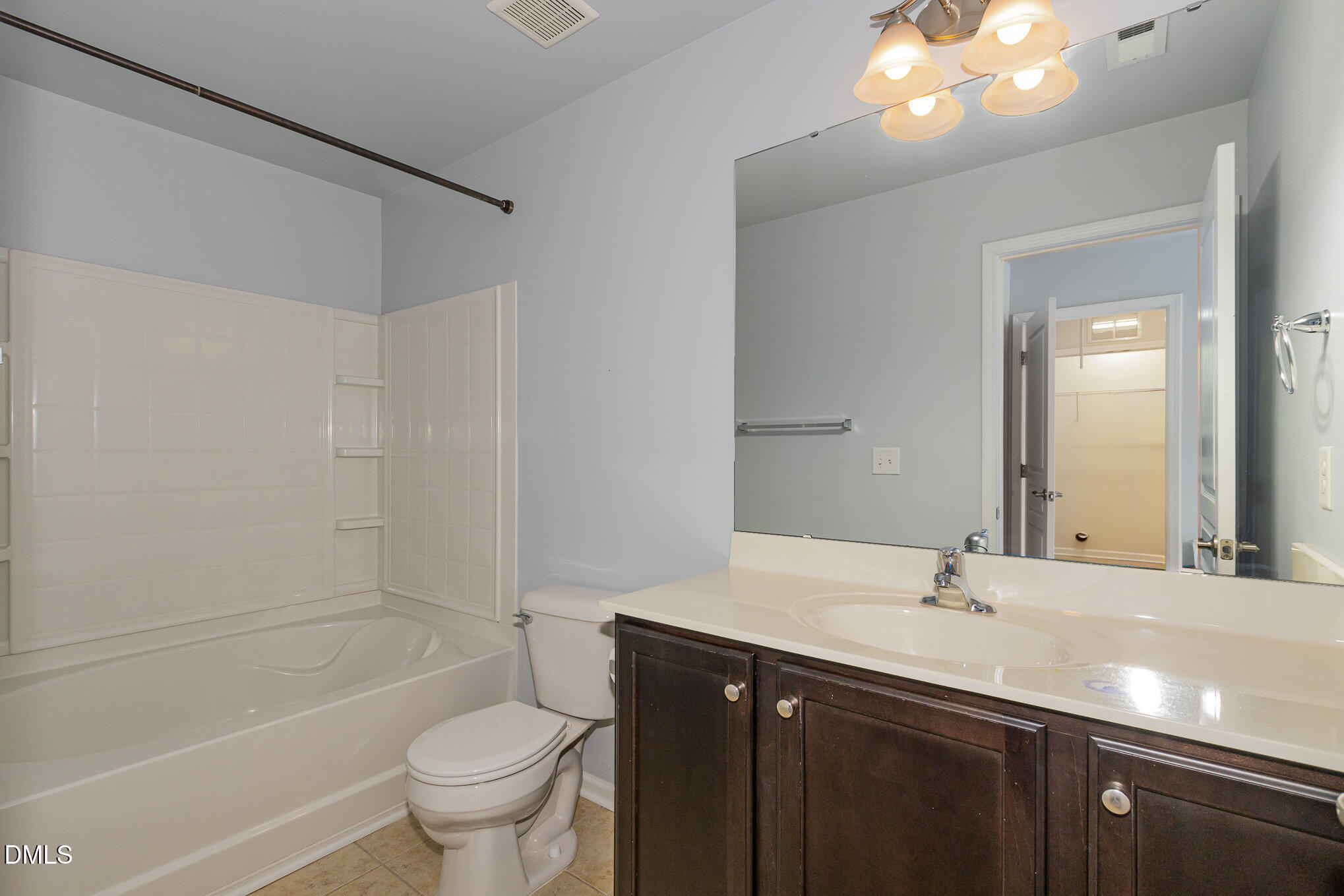 9142 Falkwood Road Raleigh, NC 27617 - Photo 23 of 33 a bathroom with a sink a toilet a mirror and shower