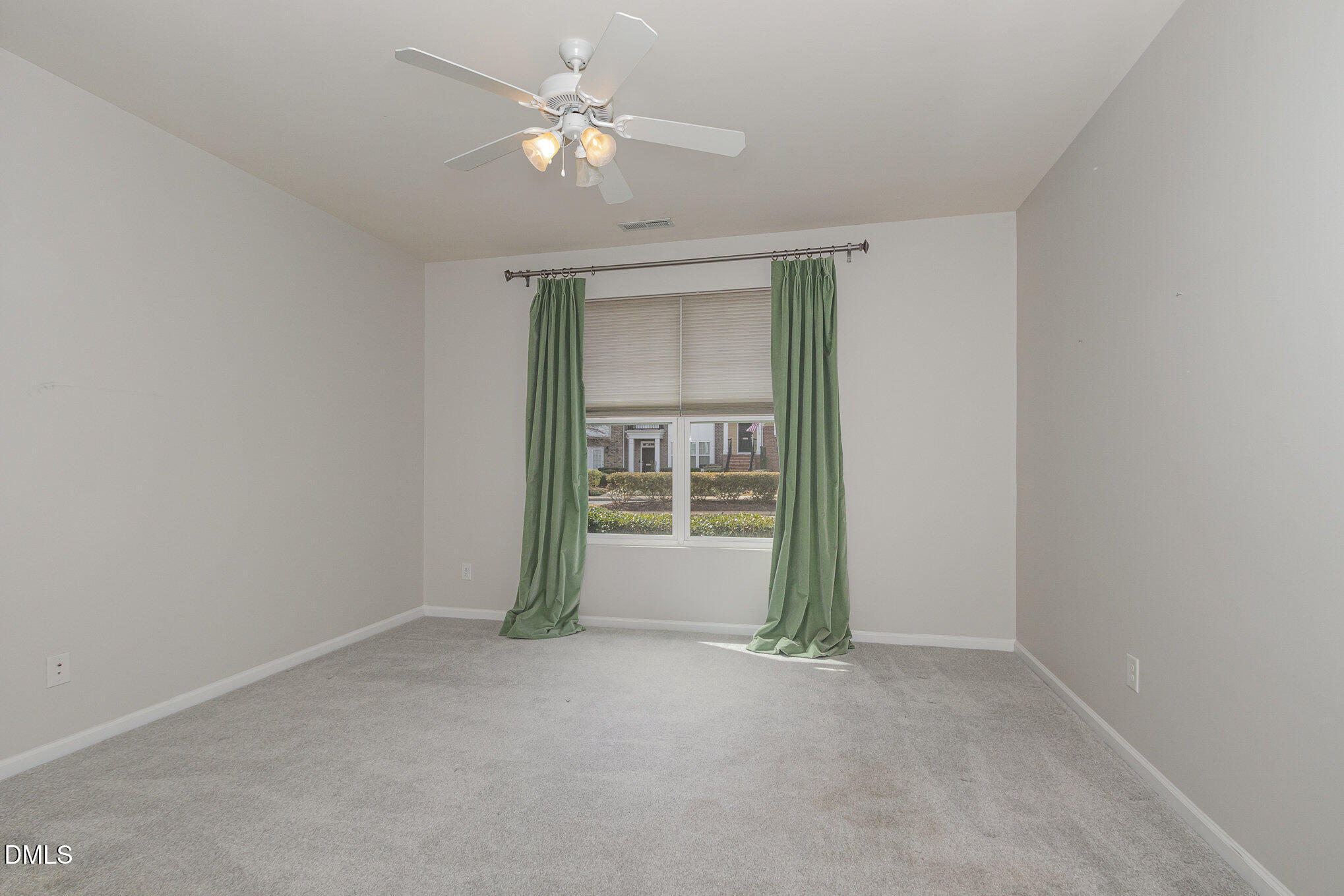 9142 Falkwood Road Raleigh, NC 27617 - Photo 24 of 33 an empty room with a ceiling fan and a window