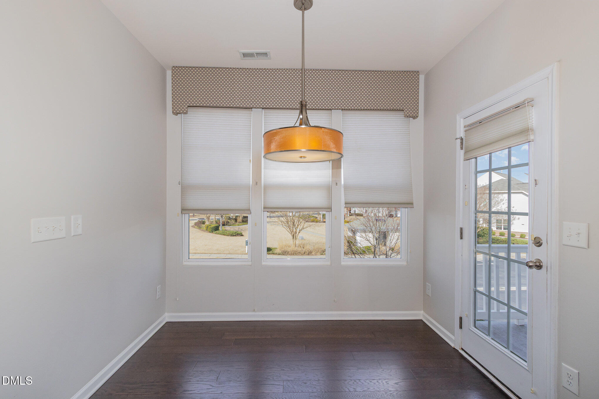 9142 Falkwood Road Raleigh, NC 27617 - Photo 7 of 33 a room with window and wooden floor