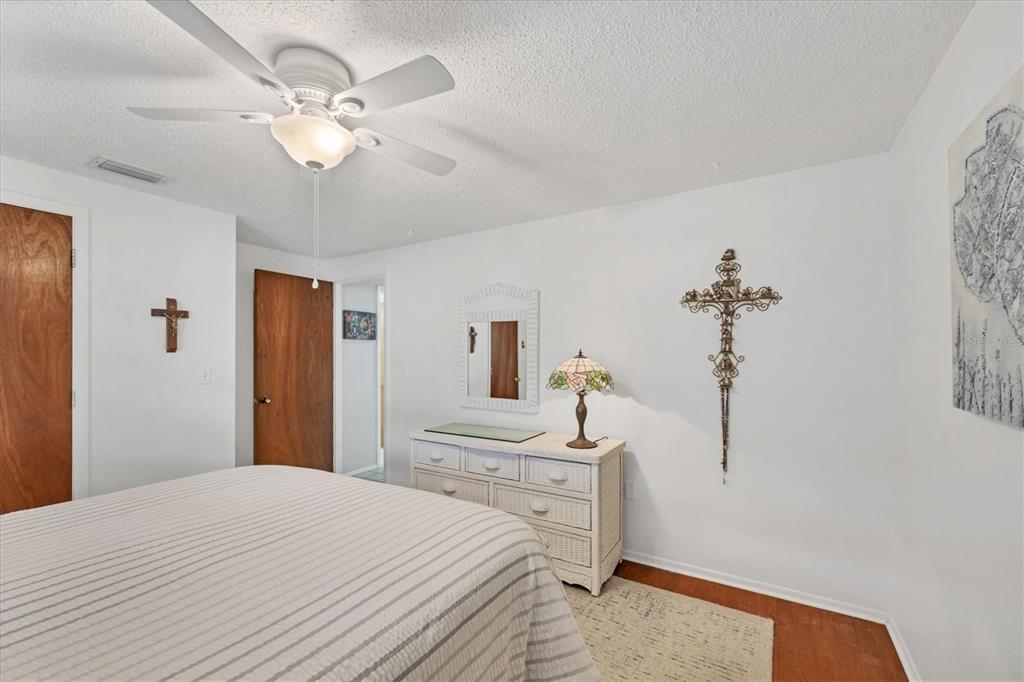 1456 Strada D Argento Venice, FL 34292 - Photo 14 of 47 a bedroom with a bed and a chandelier