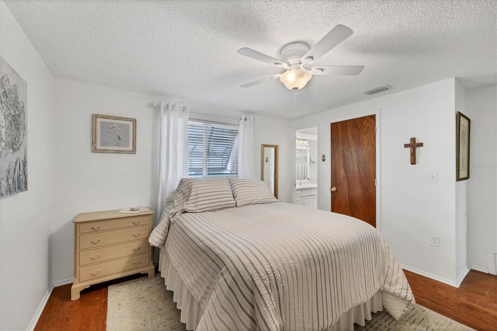 1456 Strada D Argento Venice, FL 34292 - Photo 15 of 47 a bedroom with a bed and a chandelier