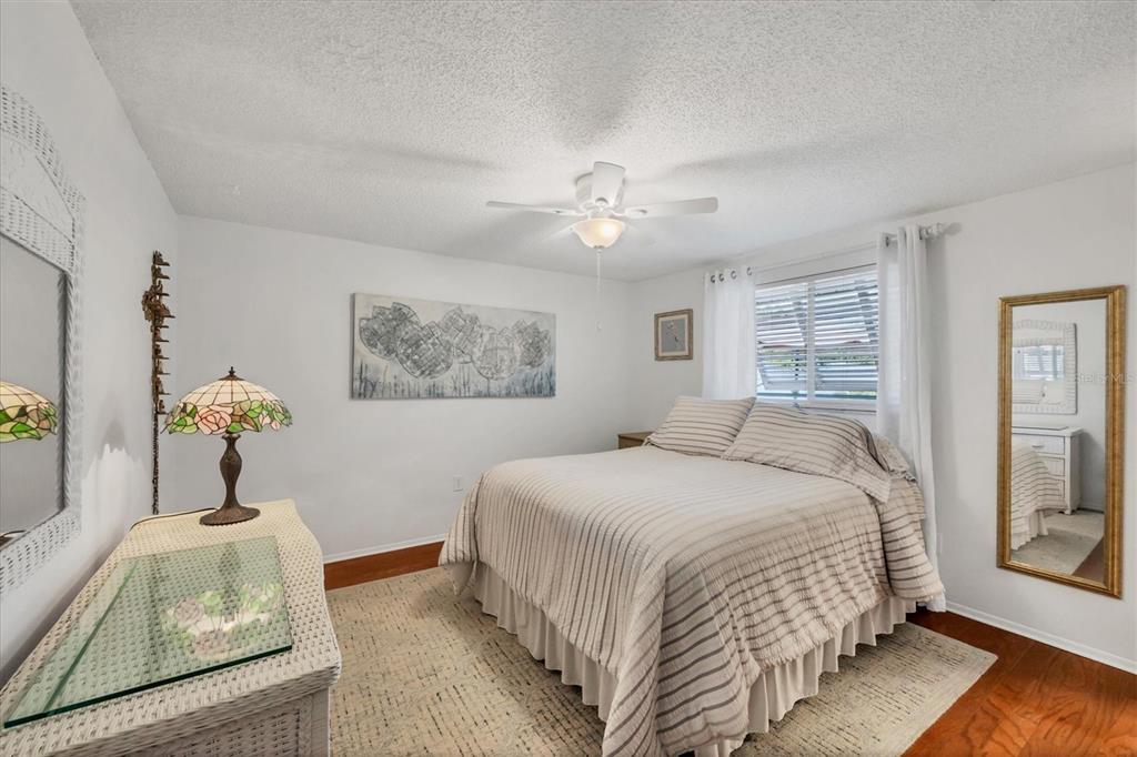 1456 Strada D Argento Venice, FL 34292 - Photo 16 of 47 a bedroom with a bed and a chandelier