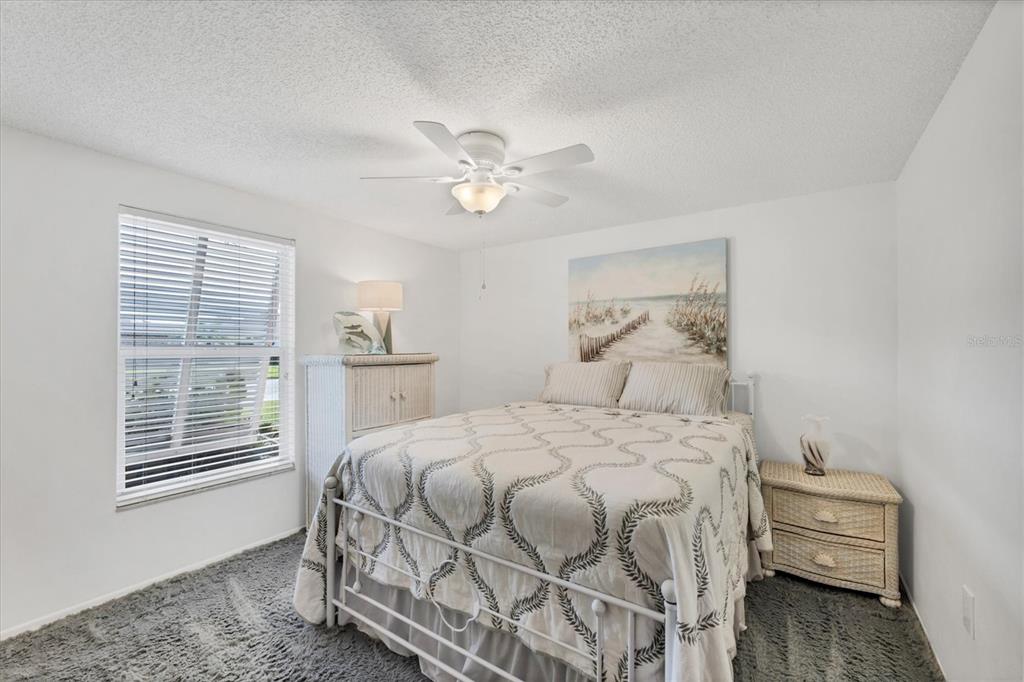 1456 Strada D Argento Venice, FL 34292 - Photo 19 of 47 a bedroom with a bed and a chandelier