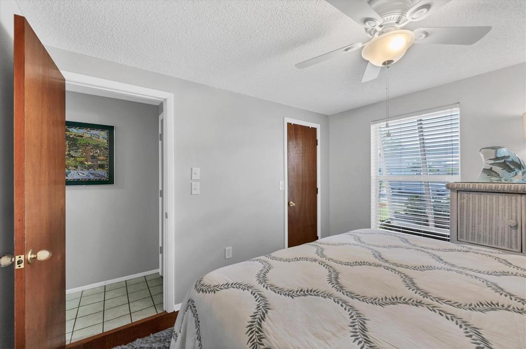 1456 Strada D Argento Venice, FL 34292 - Photo 20 of 47 a bedroom with a bed and a lamp