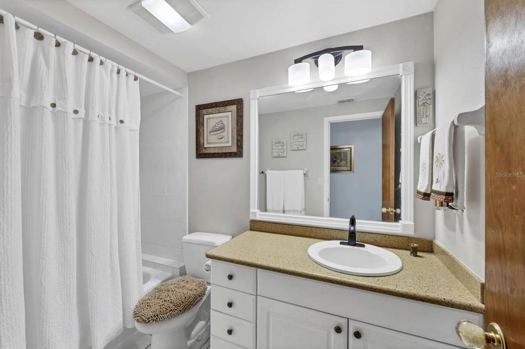 1456 Strada D Argento Venice, FL 34292 - Photo 21 of 47 a bathroom with a granite countertop sink and a mirror