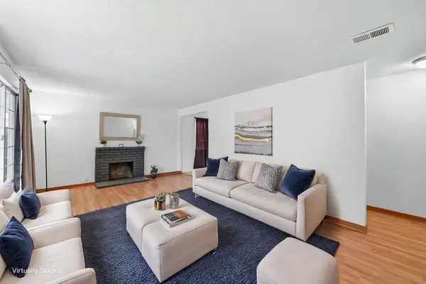 a living room with furniture a fireplace and a flat screen tv