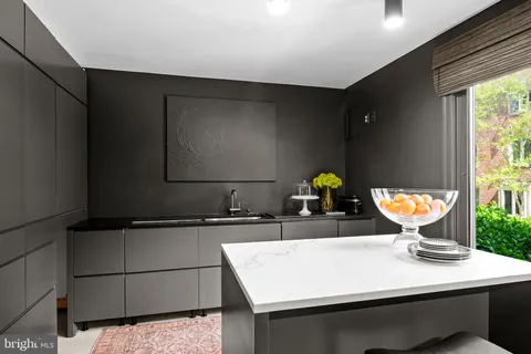 a kitchen with stainless steel appliances kitchen island granite countertop a stove a refrigerator and a dining table
