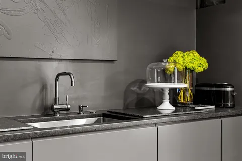 a kitchen with stainless steel appliances kitchen island granite countertop a refrigerator and a stove