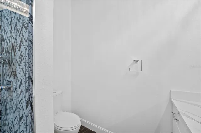 a view of a bedroom with wooden floor