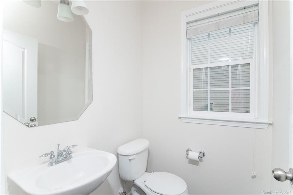 2413 Coltsgate Road Waxhaw, NC 28173 - Photo 14 of 24 a bathroom with a toilet sink and mirror