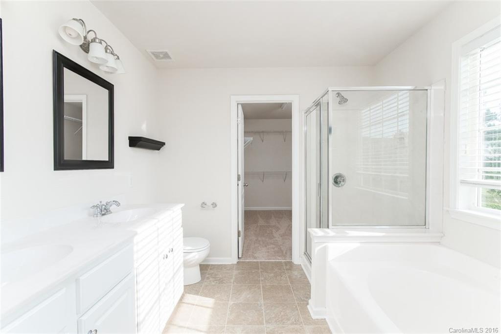 2413 Coltsgate Road Waxhaw, NC 28173 - Photo 17 of 24 a bathroom with a toilet sink and shower
